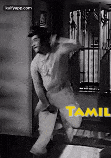 a black and white photo of a man jumping in the air with the word tamil on the bottom