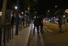 a group of people are walking down a street with a sign that says no parking