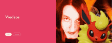 a woman with red hair is holding a red and yellow toy and the words videos are above her