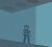 a blurry picture of a man standing in a room with a blue wall .