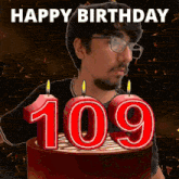 a man with glasses stands in front of a cake with the number 109 on it