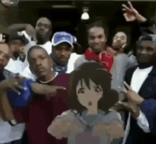 a group of people are posing for a picture with a cartoon girl .