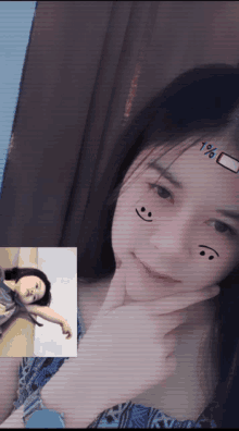 a girl with a smiley face on her face and a picture of a girl laying down