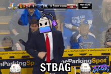 a man with a tea bag on his head stands in front of a nbc n logo