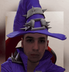 a man wearing a purple wizard hat with spikes on it