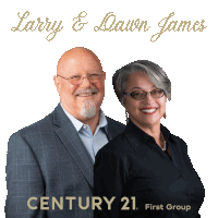 a man and a woman standing next to each other in front of a century 21 sign