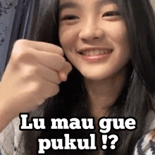 a girl with a fist up and the words lu mau gue pukul written on the bottom