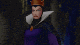 evil queen from snow white and the seven dwarfs is sitting on a throne