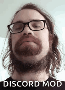 a man with glasses and a beard is wearing a black shirt with the words discord mod written on it .