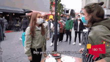 a woman wearing a mask stands in front of a table with plates of food and says ben yemek degil seni istiyorum