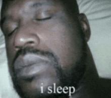 a man with a beard is sleeping with his eyes closed and the words " i sleep " next to him