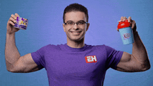 a man in a purple shirt with the letter eh on it holds up a shaker