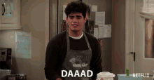 a man wearing an apron that says daaad on it