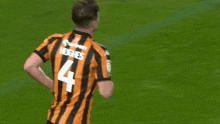a soccer player with the name hughes on the back of his shirt