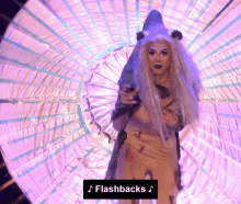 a woman in a lion king costume is standing in front of a purple background with the words flashbacks written below her