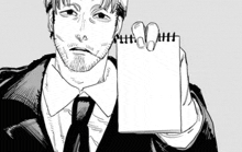 a man in a suit and tie is holding a notepad with scissors in his hand .