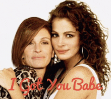 two women posing for a picture with the words " i got you babe " in red