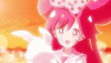 a girl with pink hair and a bow is holding a white rabbit .