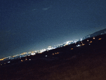 a blurry picture of a city at night with a dark sky