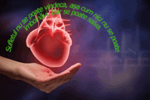 a hand is holding a heart that is glowing red