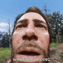 a close up of a man 's face with the words " what y'all doing " below it