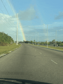 a road with a rainbow on the right side of it