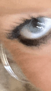 a close up of a woman 's eye with a reflection of the letter y