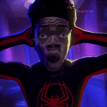 a man in a spider-man suit is holding his head