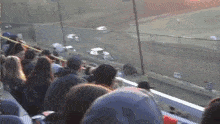 a crowd of people watching a race in a stadium with a flag that says ' u.s. ' on it