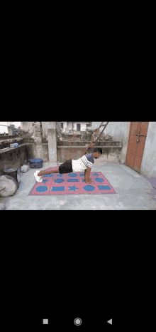 a man is doing push ups on a rug on a patio