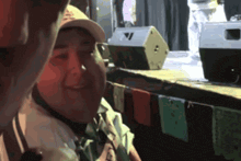 a man wearing a hat with the letter v on it smiles