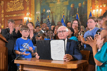 a boy in a blue shirt that says boys a girl 's club