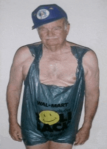 an elderly man wearing a blue hat and a walmart bag .