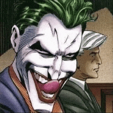 the joker is smiling with his tongue out while sitting next to another man .