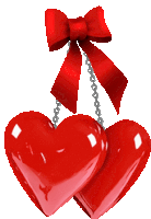 two red hearts with a red bow hanging from a chain