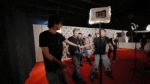 a group of people are standing on a red carpet in front of a sign that says ' k2 ' on it