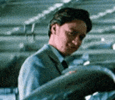 a man in a suit and tie is looking at something