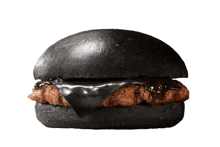 a black hamburger with a black bun and a black sauce