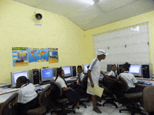 a group of children are sitting in a computer lab with eggs written on the chairs