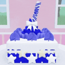 a blue and white birthday cake with a candle on top of it