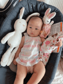 a baby is laying in a car seat with stuffed animals and a warning label