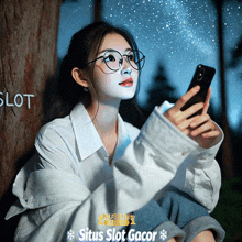 a woman with a white face is looking at her cell phone with situs slot gacor written on the bottom