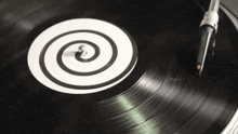 a record is being played on a turntable with a spiral on it