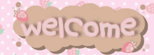 a welcome sign with strawberries and polka dots on a pink background