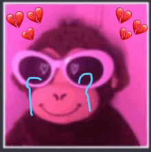 a monkey wearing sunglasses and crying with broken hearts behind him