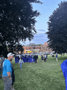 a group of people are standing in a grassy field