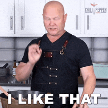 a man in an apron says " i like that " in a kitchen