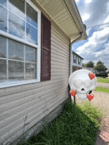 a house with a chicken shaped mailbox in front of it .