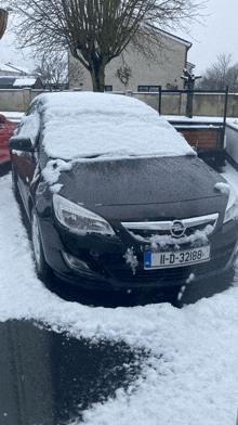 a car with a license plate that says ii-d-32188 is covered in snow