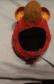 a stuffed animal with a hole in the middle of it 's mouth